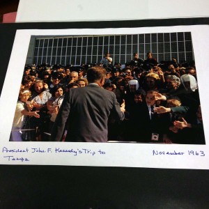 Sister Lillian shows photo of President Kennedy speaking on Macdill Ave just four days before his assassination.