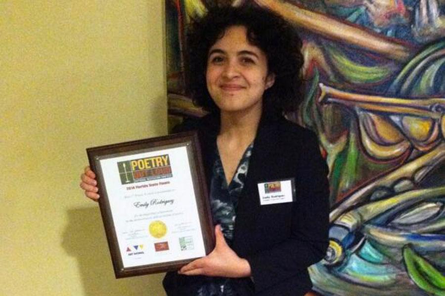 Senior Emily Rodriguez poses with her Poetry Out Loud state championship award. 