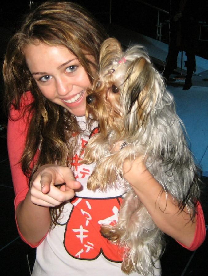 Miley shows her love for animals while cuddling with her dog in 2007!