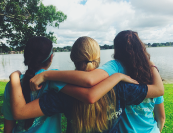 Sophomores Gretchen Swenson, Evelyn Martinez, and Julia Lavoy admire the lake. Credit: Audrey Diaz