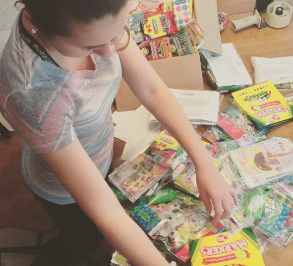 Shannon prepares a package to ship off to a child with cancer. 