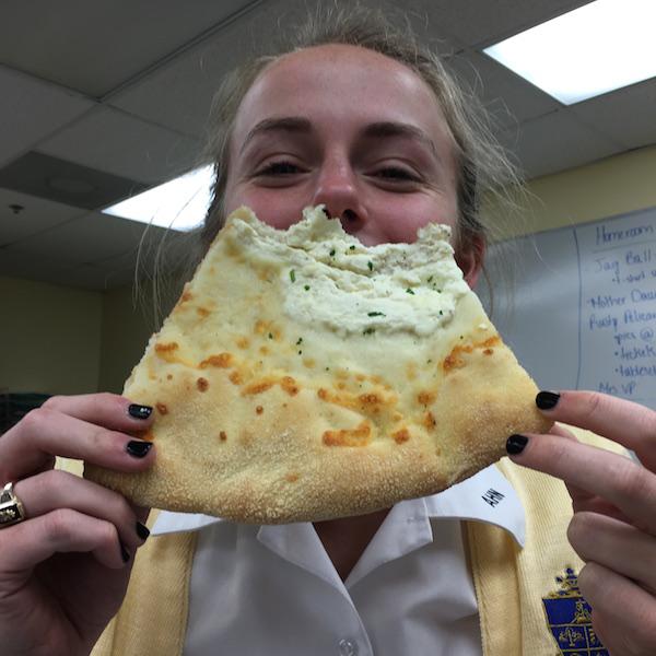 Senior Audrey Cooper happily enjoying her pizza from Tampa's own Eddie and Sam's N.Y. Pizza, something she was looking forward to eating all day.