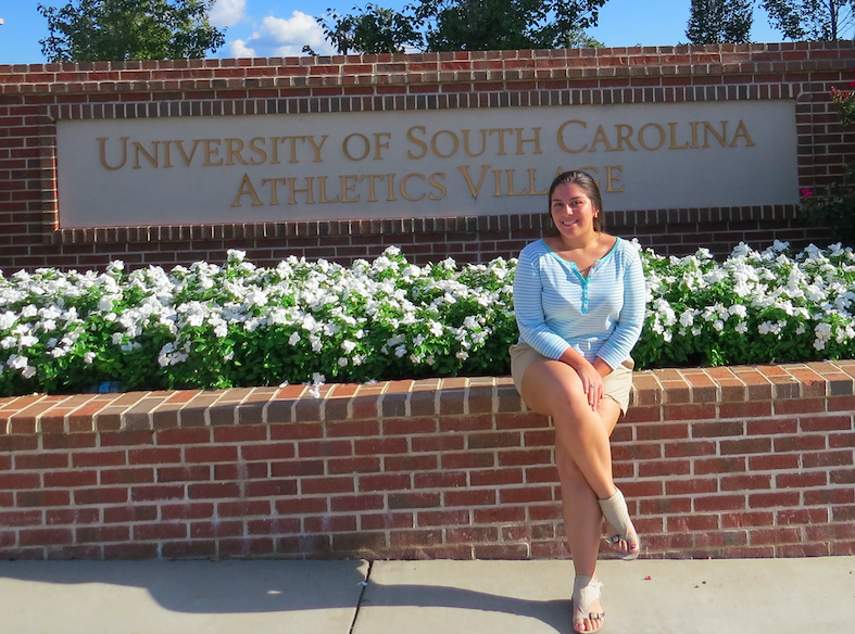 Alejandra Lozano poses in front of the Athlete's village at University of South Carolina.