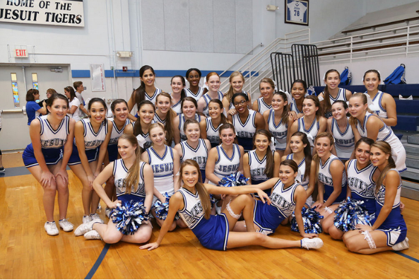 The Jesuit Cheer Team supporting the Tigers at one of their basketball games.