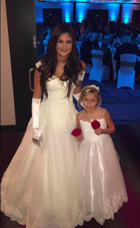 The debutantes walk beside little girls who one day are to be debutantes as well.