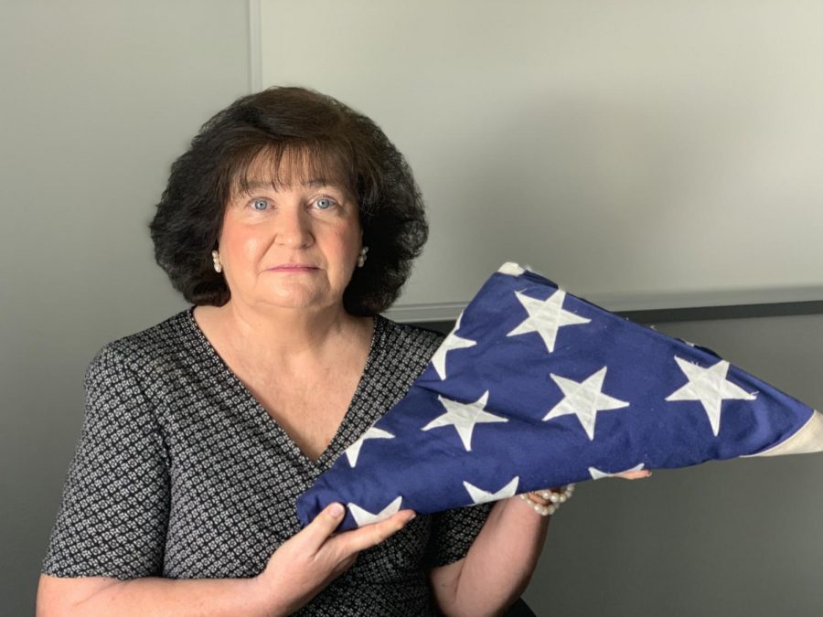 Teacher, Beth Chase, pictured with her beloved American flag which serves as a symbol of her patriotic character.  