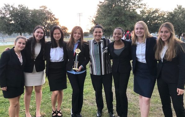 The competitors of the Academy of The Hoy Names Speech and Debate Team get in a picture after a lengthy meet. The competitors are eagerly awaiting the critiques from the judges and how they ranked. 