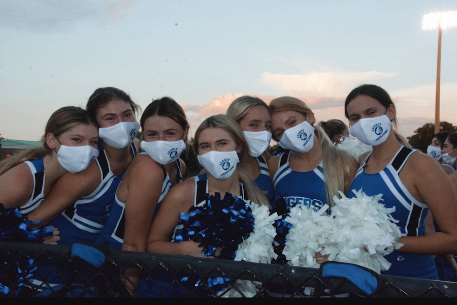 The Jesuit cheerleaders are thrilled to be back, even with masks.