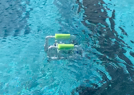 Baby Bot, a SeaPerch robot built by captains Maddie Glaum (21) and Olivia Scarpo (21), swims in the Academy pool after a successful motor test.