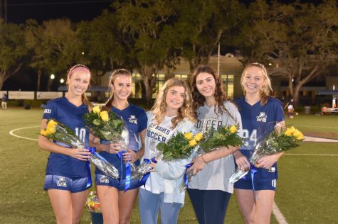 This years seniors with their bouquets. All five have been a part of the Academy soccer program for four years. 