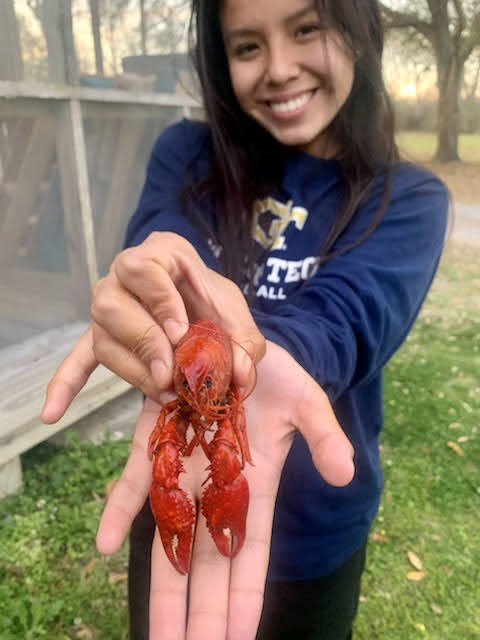 Kimberly Egoavil (23) posing with her crawfish named Tony on the Abbeville, Louisiana mission trip. 