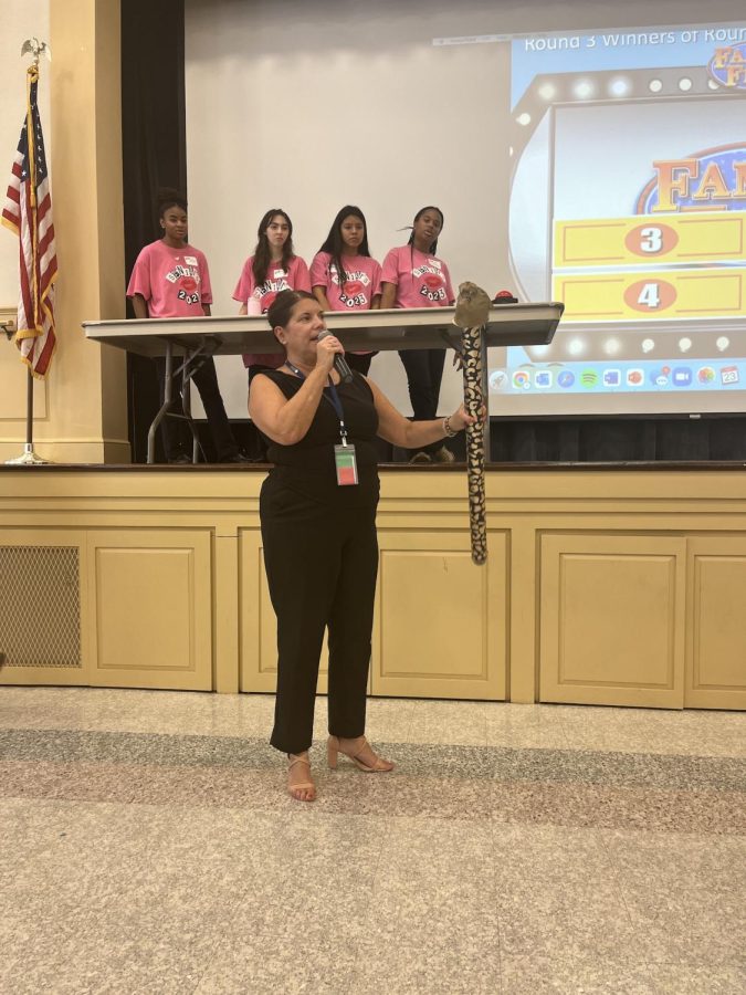 Principal, Jeanne McNamara rewarding the Seniors with the spirit stick after the victory over their fellow classmates and teachers. 