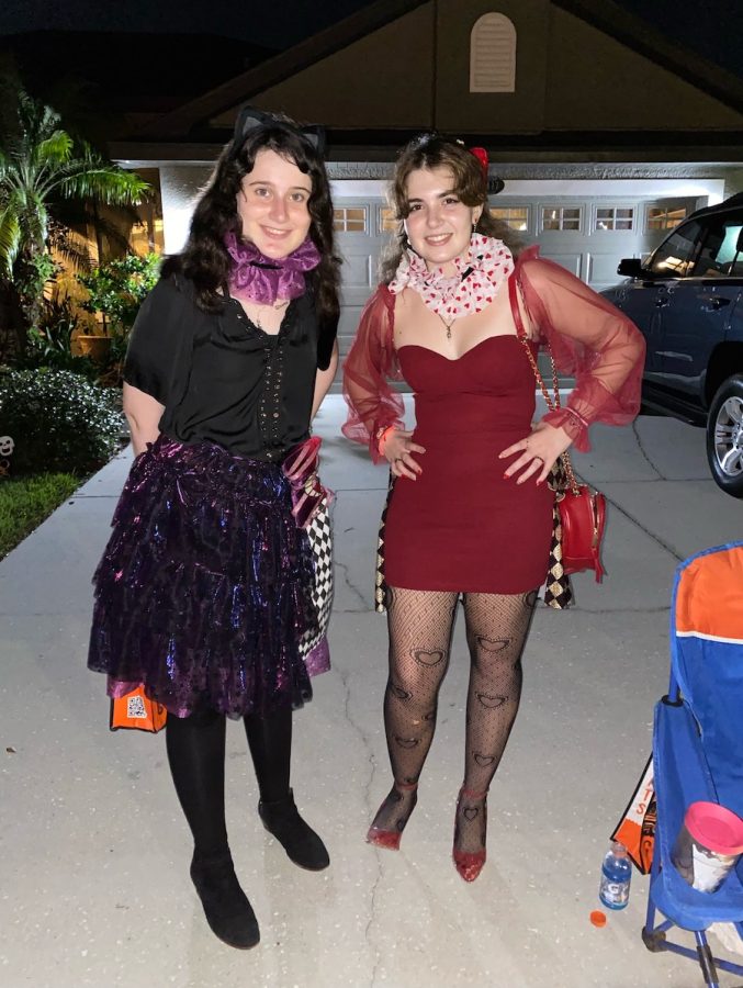 Winsome Storm (‘23) and Regi Alfonso (‘23) show off their costumes from Halloween night as they await trick-or-treaters.