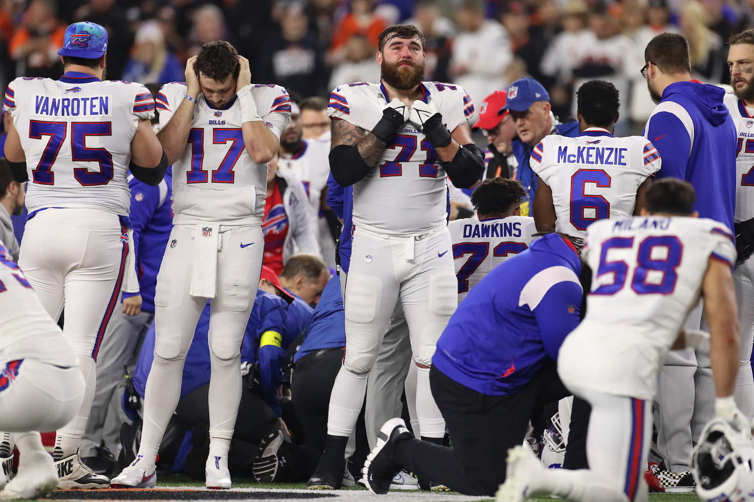 Bills players pray after their teammate, Damar Hamlin, collapses on the field. 