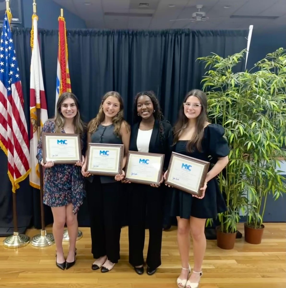 Chloe Cohen ('25), Gaby Cossi ('26), Camille King ('27), and Avery Wehling ('26) pose together at the Mayor's Youth Corps class of 2024 Closing Ceremony.
