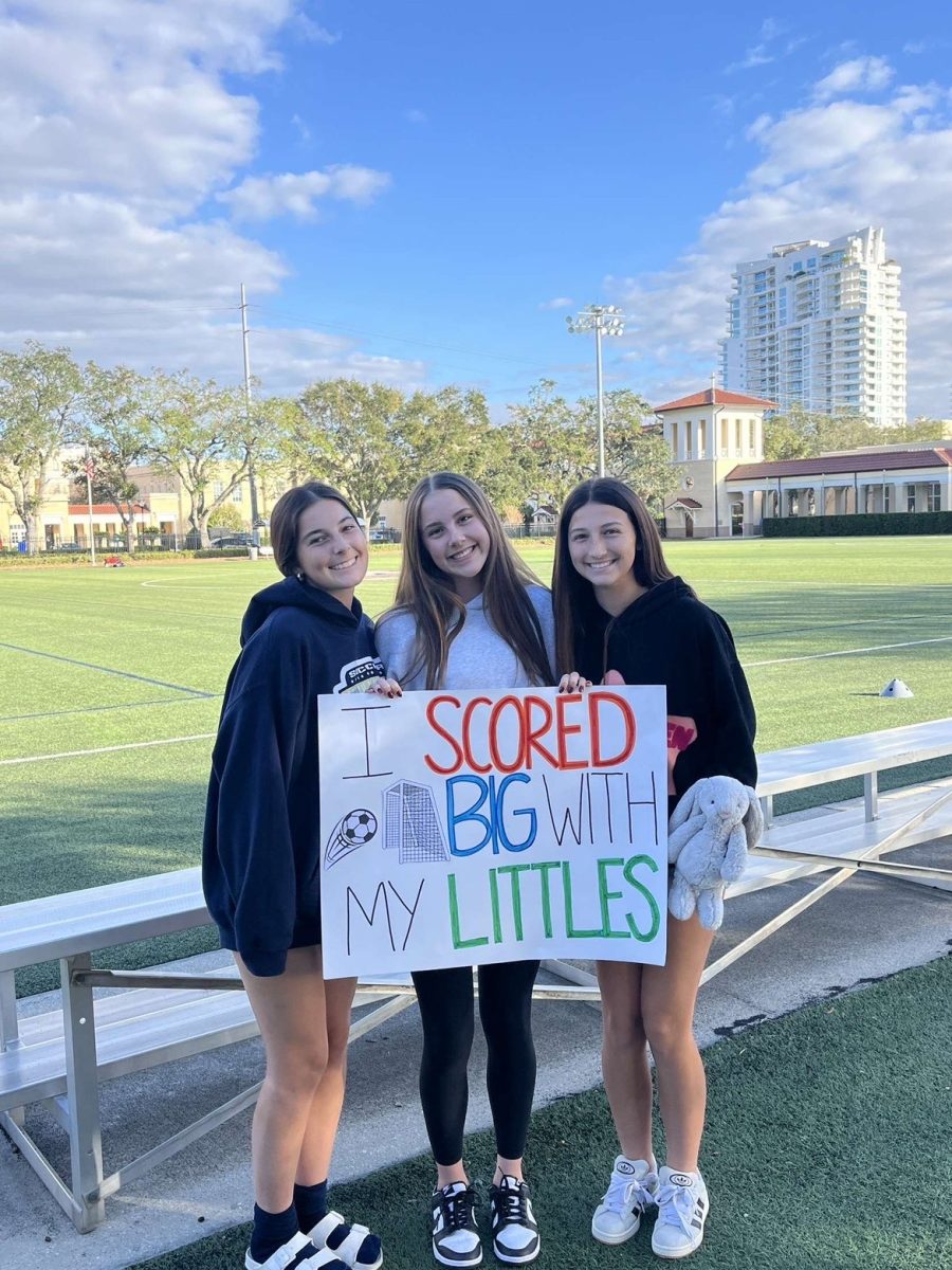 Senior Abby Doyle celebrates team tradition by revealing her new ‘littles’ on the soccer team.