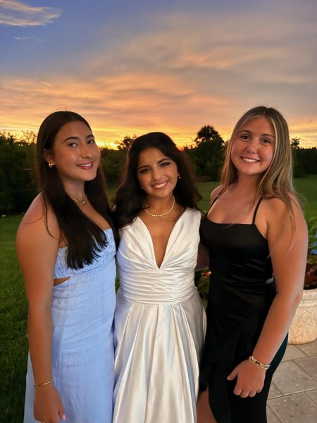 Heidi Skinner ('26) and Ameerah Kazbour ('26) and Stella Alvarez ('26) take photos after the ball.