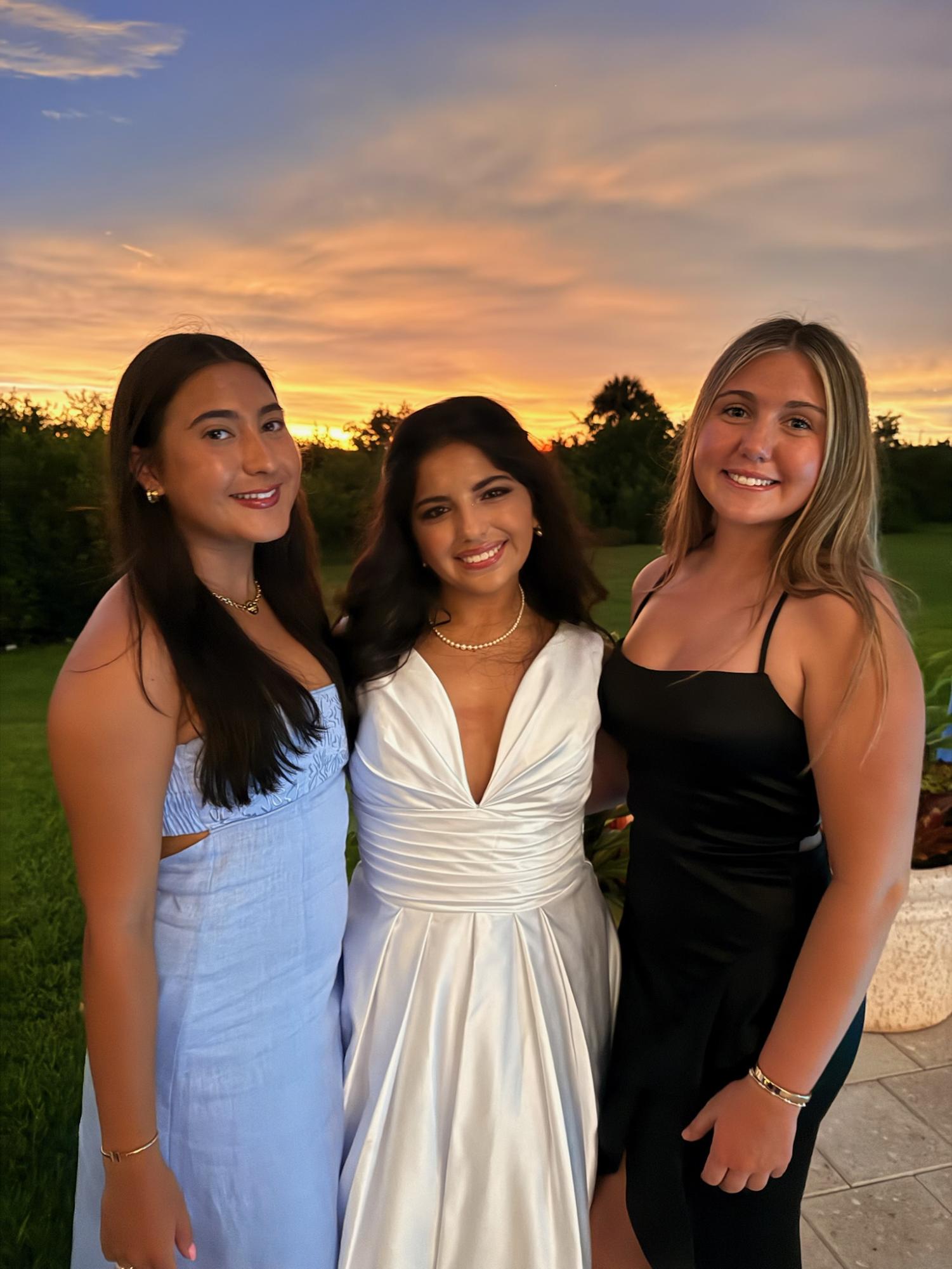 Heidi Skinner ('26) and Ameerah Kazbour ('26) and Stella Alvarez ('26) take photos after the ball.
