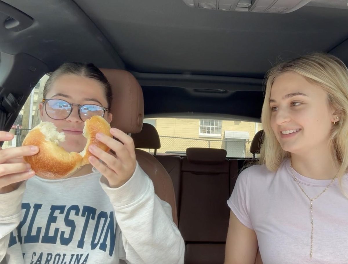 Ali Ibanez and Rosemary Garon ripping a plain bagel. 