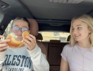 Ali Ibanez and Rosemary Garon ripping a plain bagel. 
