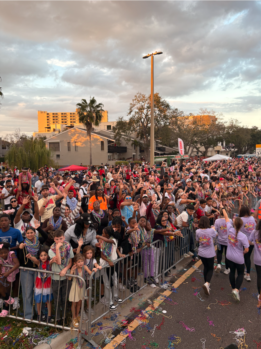 The crowd is desperately yelling for beads.